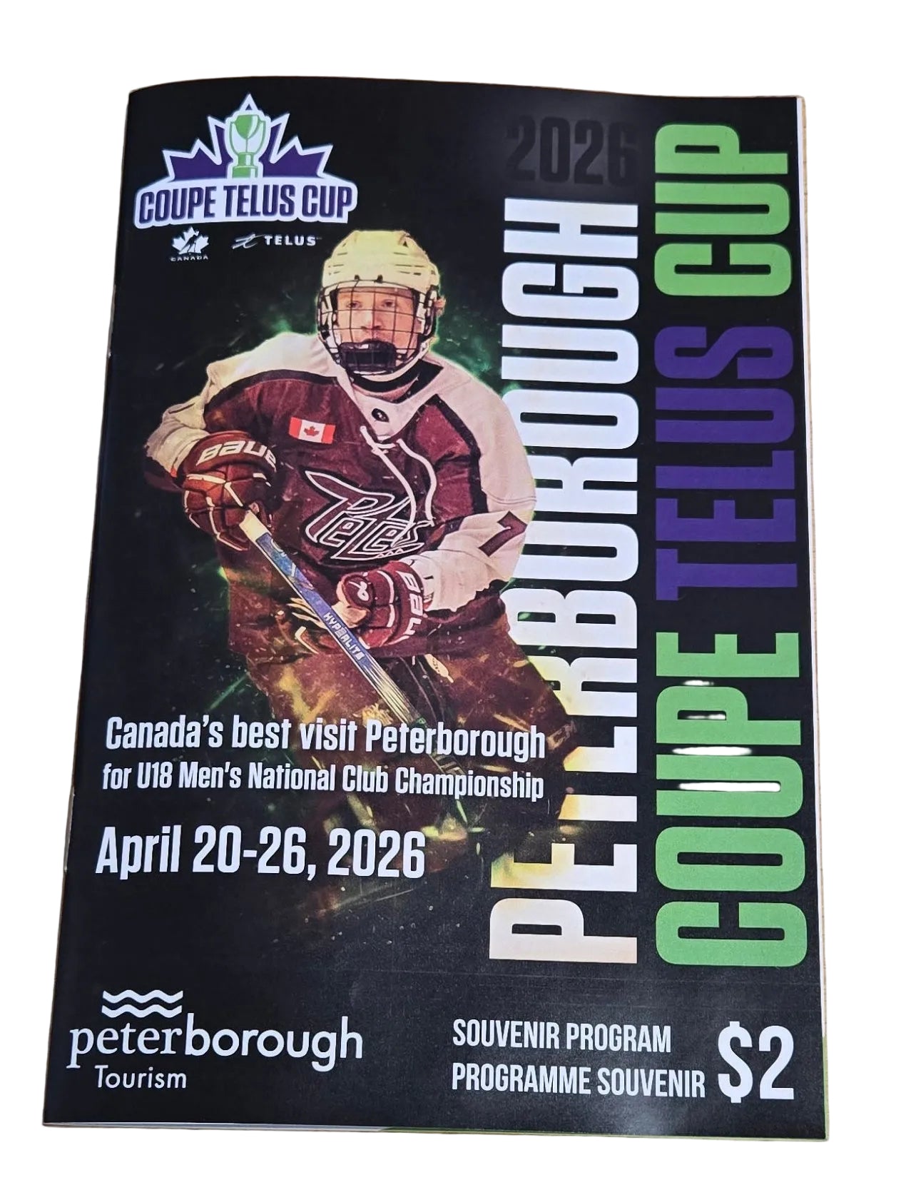 Program 2026 Peterborough Coupe Telus Cup hockey event on a wooden surface.
