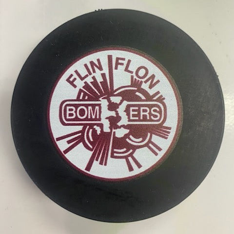 Black hockey puck with 'Flin Flon Bombers' logo on a white background