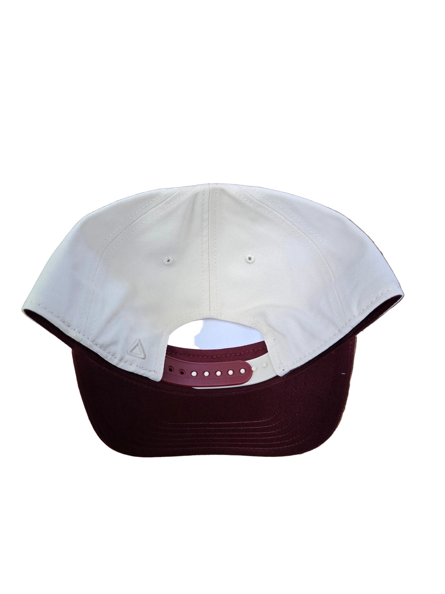 Petes cap with white front and maroon back on a wooden surface