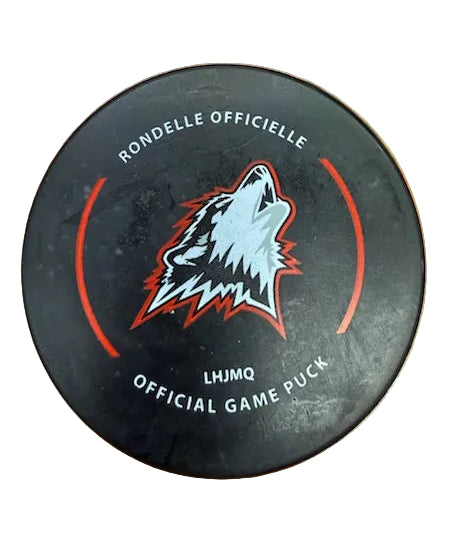 Hockey puck with wolf logo on a wooden surface